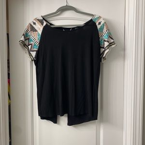 Black open back top with sequined sleeves